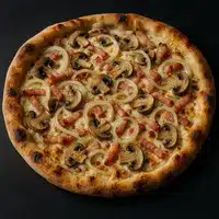 Pizza Champignons Lardons Oignons : Recette Crémeuse Pizza artisanale à croûte dorée, garnie de champignons tranchés, lardons et oignons blancs sur une base crémeuse.