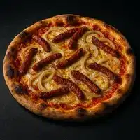 Pizza Saucisse Épicée et Oignons Caramélisés Gourmet Pizza gourmet avec saucisses épicées allongées (tipo chorizo/salami) et fines rondelles d'oignon caramélisées sur une base de fromage fondu.